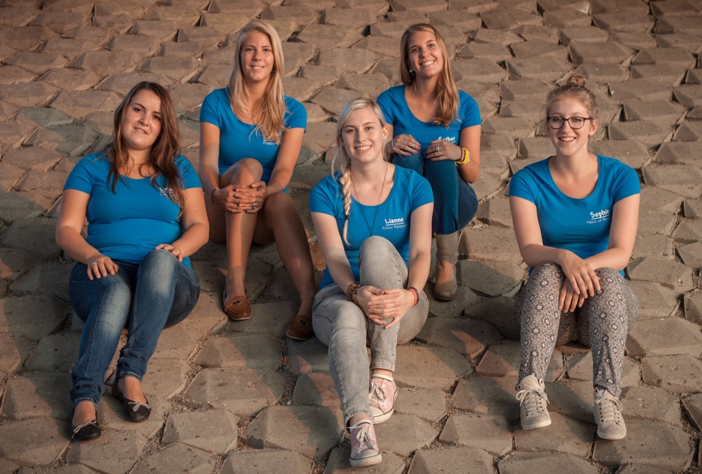Picture of the five boardmembers sitting on a stone hill.